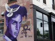 FILE - In this Aug 28, 2016, file photo, a mural honoring the late Prince adorns a building in the Uptown area of Minneapolis. The one-year anniversary of the rock star, who died of an overdose at the age of 57, is April 21.