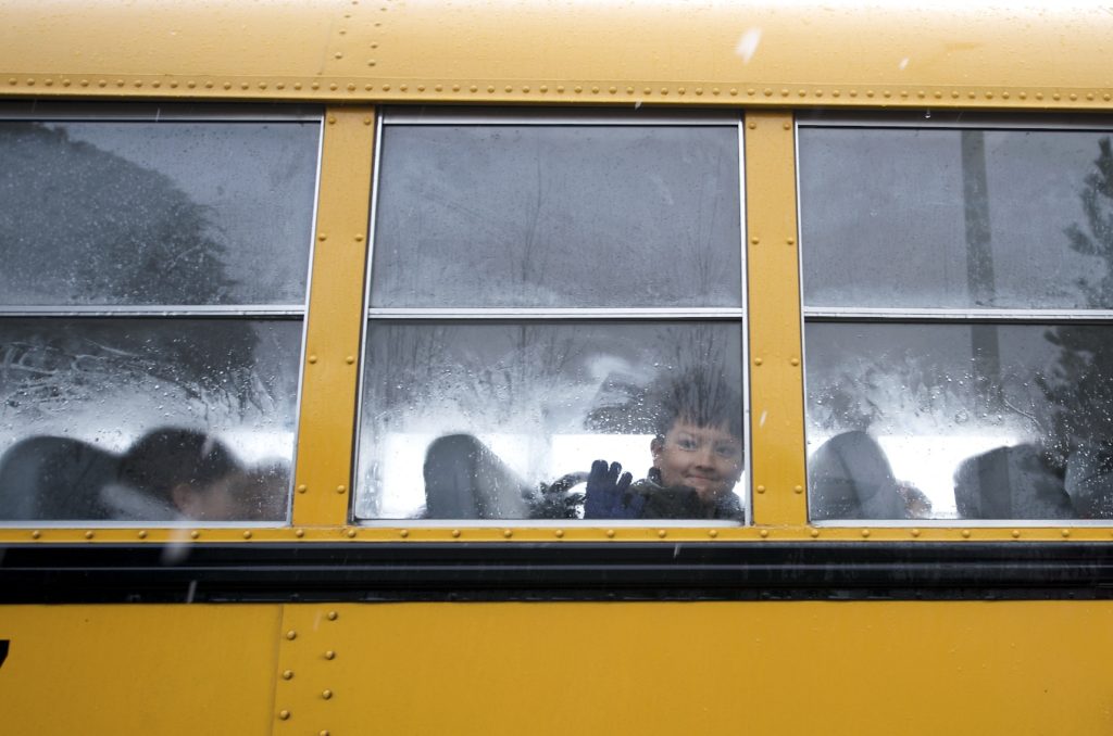 Justin Flores, 8, of Vancouver waves goodbye to his mom as he peers through a foggy bus window Thursday morning March 27, 2008. Cold weather brought a flurry of snow mixed with rain for many students who made their way to school this morning.