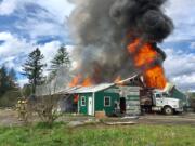 A two-alarm fire destroyed a pole barn Wednesday afternoon northwest of Battle Ground.