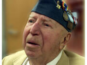 Willis Earl receives a medal from the Veterans of Underage Military Service in 2001.