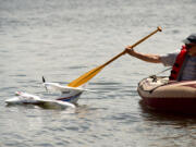 Dean Swift, a 20-year member of the Clark County Radio Control Society, fishes club member Jeff McIlvenna&#039;s waterlogged plane from Vancouver Lake Sunday afternoon. The club had its 8th annual float plane flying event Sunday at the lake.