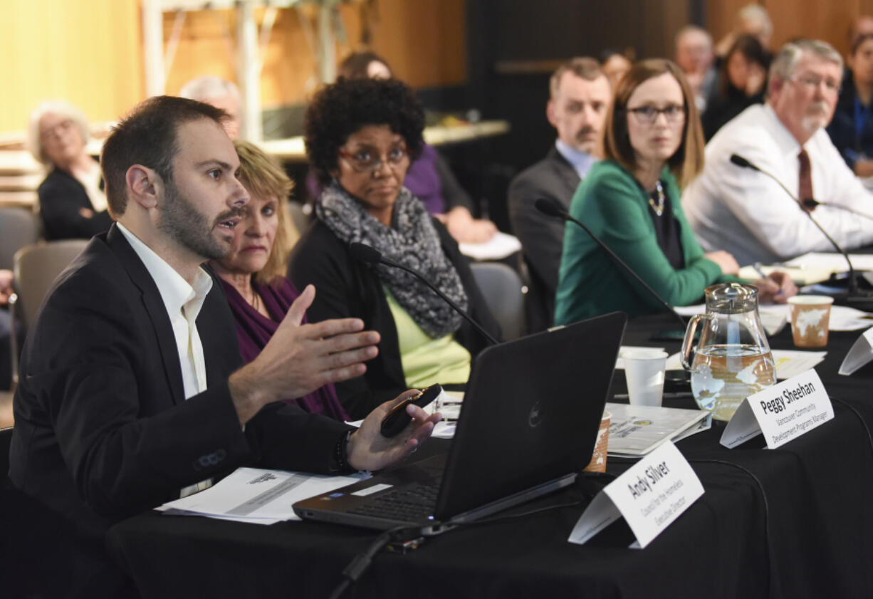 Executive Director of the Council for the Homeless Andy Silver, left, speaks May 1 about homelessness in Vancouver to the Vancouver City Council and the Board of County Councilors at the Vancouver Community Library.