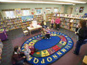 Kids and parents arrive for story time in the Woodland Community Library in 2015. Library advocates say the century-old building is too small, and regional library trustees voted Monday to buy a site for a new branch.