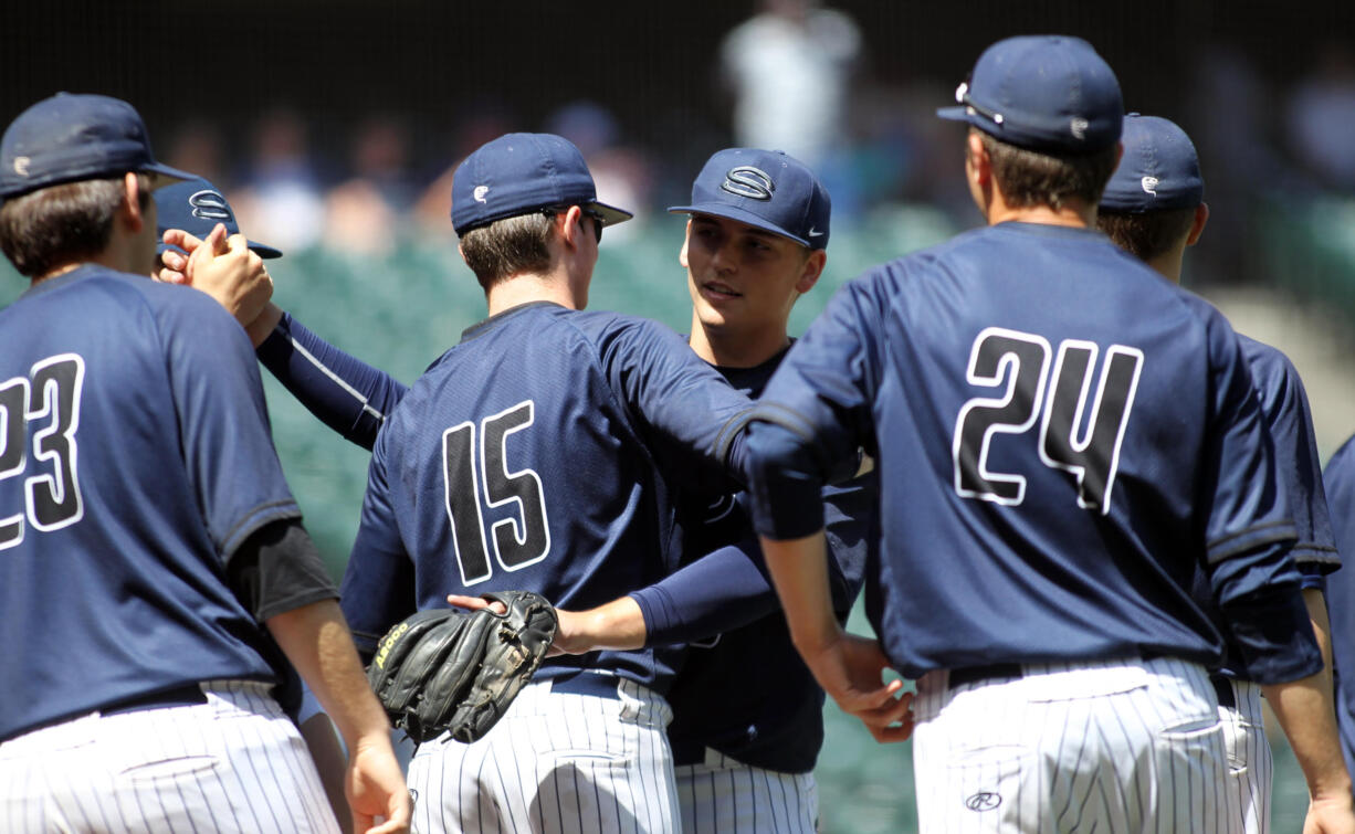 Skyview senior Nick Jennings gets a congratulation hung from Chis Swan after they beat Kentwood in the WIAA 4A state baseball championship's 3rd place  game Saturday May 27, 2017 at Safeco Field in Seattle.  Skyview beat Kentwood 7-3 to earn 3rd place.