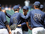 Skyview senior Nick Jennings gets a congratulation hung from Chis Swan after they beat Kentwood in the WIAA 4A state baseball championship's 3rd place  game Saturday May 27, 2017 at Safeco Field in Seattle.  Skyview beat Kentwood 7-3 to earn 3rd place.