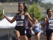 Union's Dai'lyn Merriweather, left, reacts to crossing the finish line in 1st place while running the anchor leg of the 4A Girls 4x200 Meter Relay at the WA State Track and Field Meet Saturday, May 27, 2017, in Tacoma, Wash.