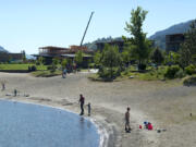 Construction continues along the Hood River waterfront as families enjoy the sunshine at Hood River Waterfront Park on May 19.