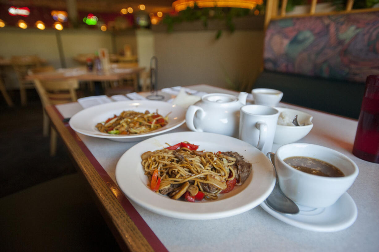 At Golden Tent Mongolian Grill, you can essentially order up exactly what you want, choosing your own meat and veggies that get quickly stir-fried. Then, you add sauces if you want. Here you can see a bowl with chicken, left, and another with lamb.