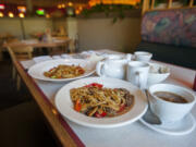 At Golden Tent Mongolian Grill, you can essentially order up exactly what you want, choosing your own meat and veggies that get quickly stir-fried. Then, you add sauces if you want. Here you can see a bowl with chicken, left, and another with lamb.