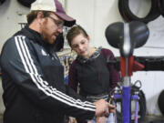 Bike Clark County co-manager Aaron Gibson, left, helps Hudson’s Bay High School freshman Natalie Oliver fix a bike during the Bike 2 Leadership.