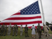 Participants in the annual Memorial Day Observance help with the dedication of the newly reconstructed Garrison flagstaff during the ceremony at Fort Vancouver National Historic Site on Monday morning.