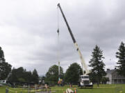 A crane hoists the new flagpole into position Thursday morning at Fort Vancouver National Historic Site.