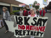 Longview resident Diane Dick, center, walks in a crowd of demonstrators to toward the Washington Department of Ecology’s office in Orchards. The crowd opposed the NW Innovation Works methanol refinery proposed for Kalama. If approved, it would be the largest of its kind in the world.