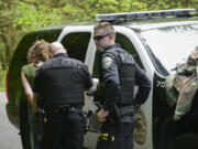 La Center Police Officer Andy Marvitz, right, covers for Sergeant Robert Scott during a welfare check after Marvitz had to stall while waiting for backup. The La Center Police Department is at minimum staffing levels to provide 24-hour service, and with an uncertain financial future in the city, the department might not be able to bring in additional help.