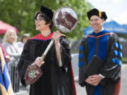 Elizabeth Soliday, left, associate professor of human development, carries in Washington State University Vancouver&#039;s ceremonial mace during Saturday&#039;s commencement with Chancellor Mel Netzhammer, right. (Randy L.