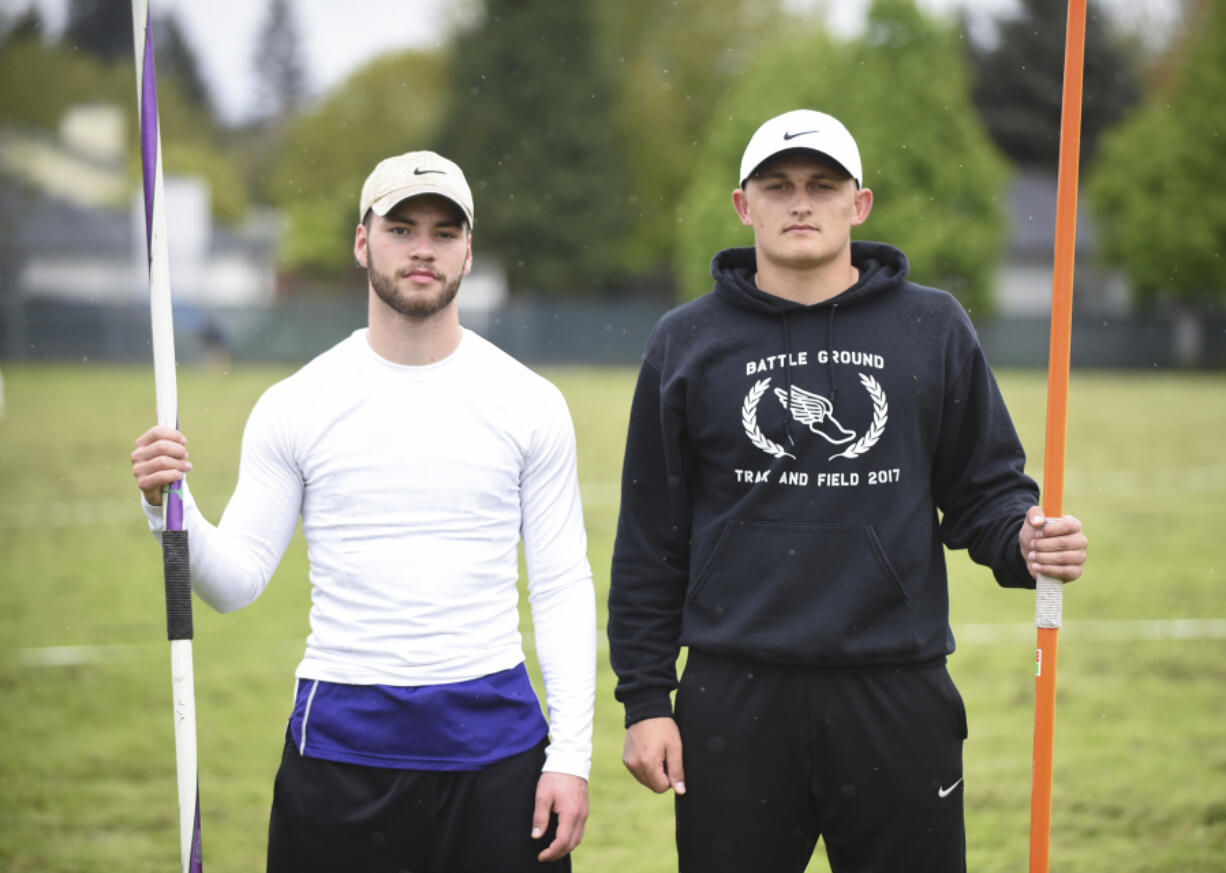 Heritage High School senior Gavin Lee, left, and Battle Ground High School senior Curtis Stradley, are pictured with their javelins before a track meet at Heritage High School (Ariane Kunze/The Columbian)