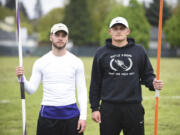 Heritage High School senior Gavin Lee, left, and Battle Ground High School senior Curtis Stradley, are pictured with their javelins before a track meet at Heritage High School (Ariane Kunze/The Columbian)