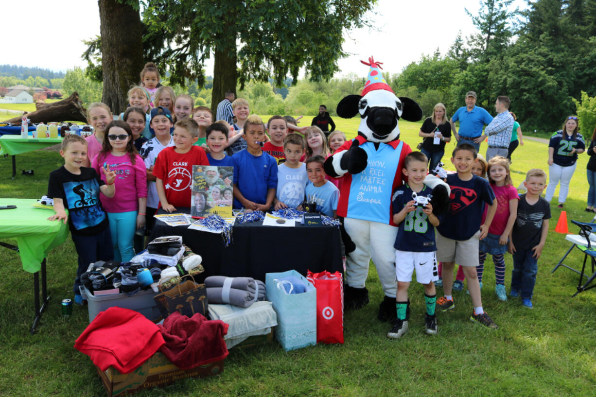 Bennington: Evan Yost, in Seahawks jersey, celebrated his eighth birthday with 35 friends, but instead of gifts, he asked everyone to bring towels, socks and blankets to be donated to the Portland Rescue Mission.