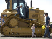 Simon Barbashin 6, climbs on a bulldozer Sunday at Dozer Day at the Grandstand at the Clark County Fairgrounds. The event, organized by the Nutter Family Foundation, offered vehicles ranging from ambulances to dump trucks to excavators for kids and their families to explore.