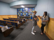 Jordan Shaw, lead youth pastor at Faith Center Church, holds baby Hazel Shaw, 2 months, as he encourages Daybreak outpatient client Taylor Ledesma, 18, during a tour of the Daybreak Youth Services RWC Center for Adolescent Recovery in Brush Prairie.