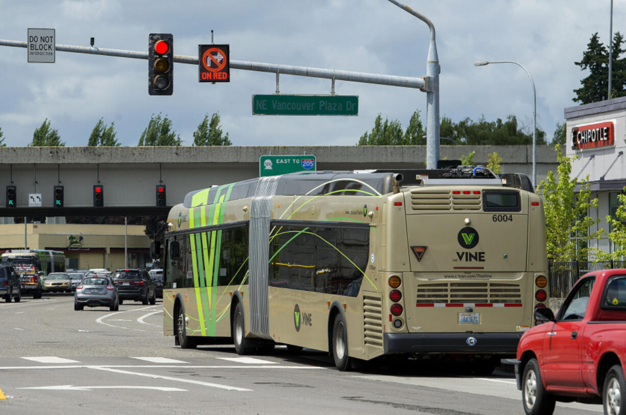 A Vine bus gets an early start through the intersection of Northeast Vancouver Plaza Drive and Thurston Way in Vancouver thanks to a queue-jump signal installed at the intersection. The signal gives the bus a 10-second head start over other cars stopped at the light.