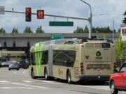 A Vine bus gets an early start through the intersection of Northeast Vancouver Plaza Drive and Thurston Way in Vancouver thanks to a queue-jump signal installed at the intersection. The signal gives the bus a 10-second head start over other cars stopped at the light.