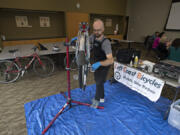 Aaron Michalson, owner of Left Coast Bicycles, repairs a bicycle during mobile bike clinic at Vancouver City Hall on Thursday. The clinic was aimed at getting downtown cyclists’s rides tuned up and ready for the biking season.