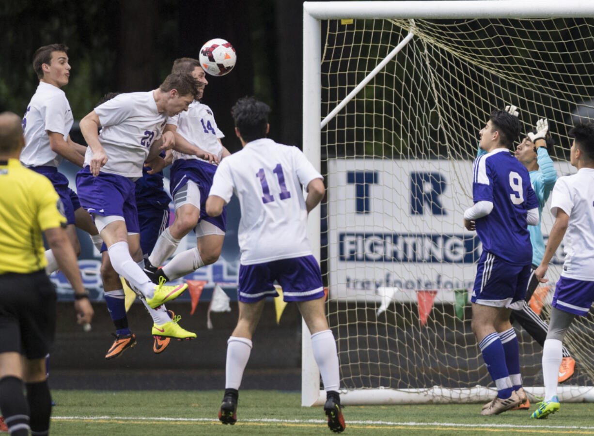 Columbia Riverís Ryan Connop (23), heads the ball into the goal in what was initially thought to be the fourth goal for Columbia River during overtime in the first round of the 2A state playoffs against Highline at the Kiggins Bowl in Vancouver, Tuesday May 16, 2017.