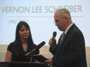 Pat Vichas, left, wife of District Court Judge Vernon L. Schreiber, accepts a plaque from Clark County Councilor Marc Boldt during a celebration of life Saturday at the Clark County Event Center at the Fairgrounds.