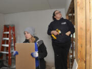 Greg Wahl-Stephens for the Columbian
A volunteer for Evergreen Habitat for Humanity, Lydia Waik, left, hangs sheetrock with homeowner Crystal Helsel on Saturday during Habitat’s 10th annual National Women Build Week. Helsel’s home is one of 10 in the McKibbin Commons subdivision in Vancouver’s Father Blanchet Park neighborhood.