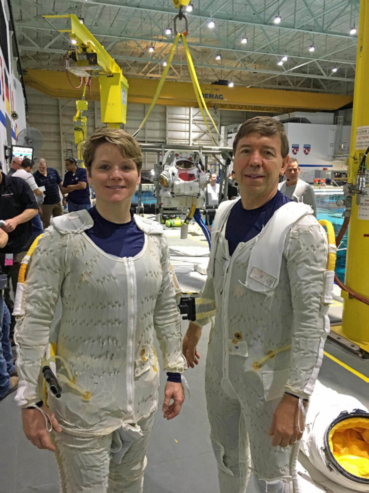 Astronauts Anne McClain, left, and 1977 Camas High School graduate Mike Barratt in their liquid-cooled garments before suiting up for an underwater training session in NASA’s neutral buoyancy tank. McClain flew 216 combat missions in Iraq as a Kiowa Warrior helicopter pilot.