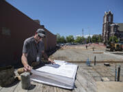 Joe Lenahan, a building inspector for the city of Vancouver, looks over plans for the expanding of Heathen Brewing Feral Public House. The planned 200-seat patio is the latest endeavor for Heathen, which also recently opened a vineyard.