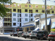 Metered parking lines West 17th Street near Main Street in downtown Vancouver, where a new apartment complex is being built. The construction has temporarily eliminated parking on parts of Main Street and West 17th Street. The building will have 167 apartments.