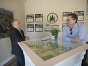 Steve Bradford, vice president of sales and marketing for Pacific Lifestyle Homes, talks with owner Kevin Wann inside a model home at Whispering Pines in northeast Battle Ground. “We’re a local builder and we like to donate locally as well,” Bradford said.