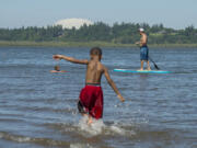 Amelia Burik, left, 4, of Vancouver enjoys the water and sunshine with her dad, Nick, right, at Vancouver Lake in 2017.