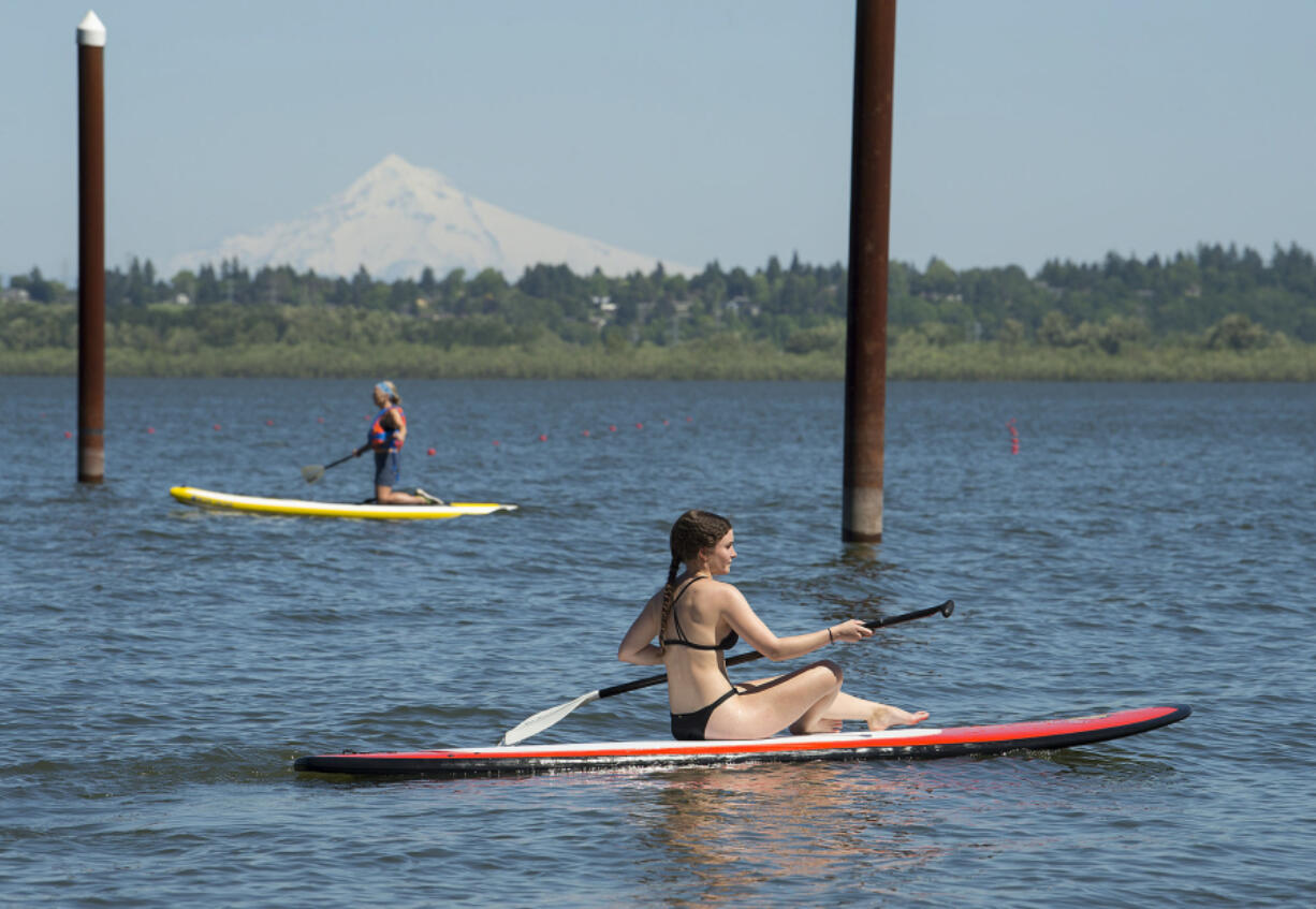 Lexie Ellis, 18, of Portland enjoys the water and sunshine while paddleboarding at Vancouver Lake in 2017.