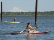 Lexie Ellis, 18, of Portland enjoys the water and sunshine while paddleboarding at Vancouver Lake in 2017.