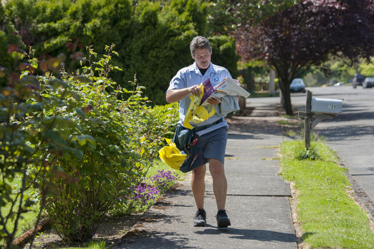 Letter carrier Bob Weyer delivers mail and a yellow bag for the 25th annual Letter Carriers’ Stamp Out Hunger Food Drive. He walks 10.5 miles daily delivering mail to residents in the Carter Park neighborhood and believes his customers will come through with donations for the food drive. “I’m the luckiest guy I know. All of my customers are so generous and so nice,” Weyer said.