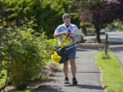 Letter carrier Bob Weyer delivers mail and a yellow bag for the 25th annual Letter Carriers’ Stamp Out Hunger Food Drive. He walks 10.5 miles daily delivering mail to residents in the Carter Park neighborhood and believes his customers will come through with donations for the food drive. “I’m the luckiest guy I know. All of my customers are so generous and so nice,” Weyer said.