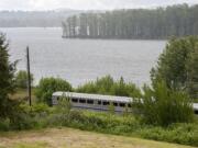 An Amtrak passenger train waits on the tracks in Camas after a collision with a vehicle near Southwest Viola Street on Tuesday morning. One person was killed in the incident and one person was taken to the hospital.