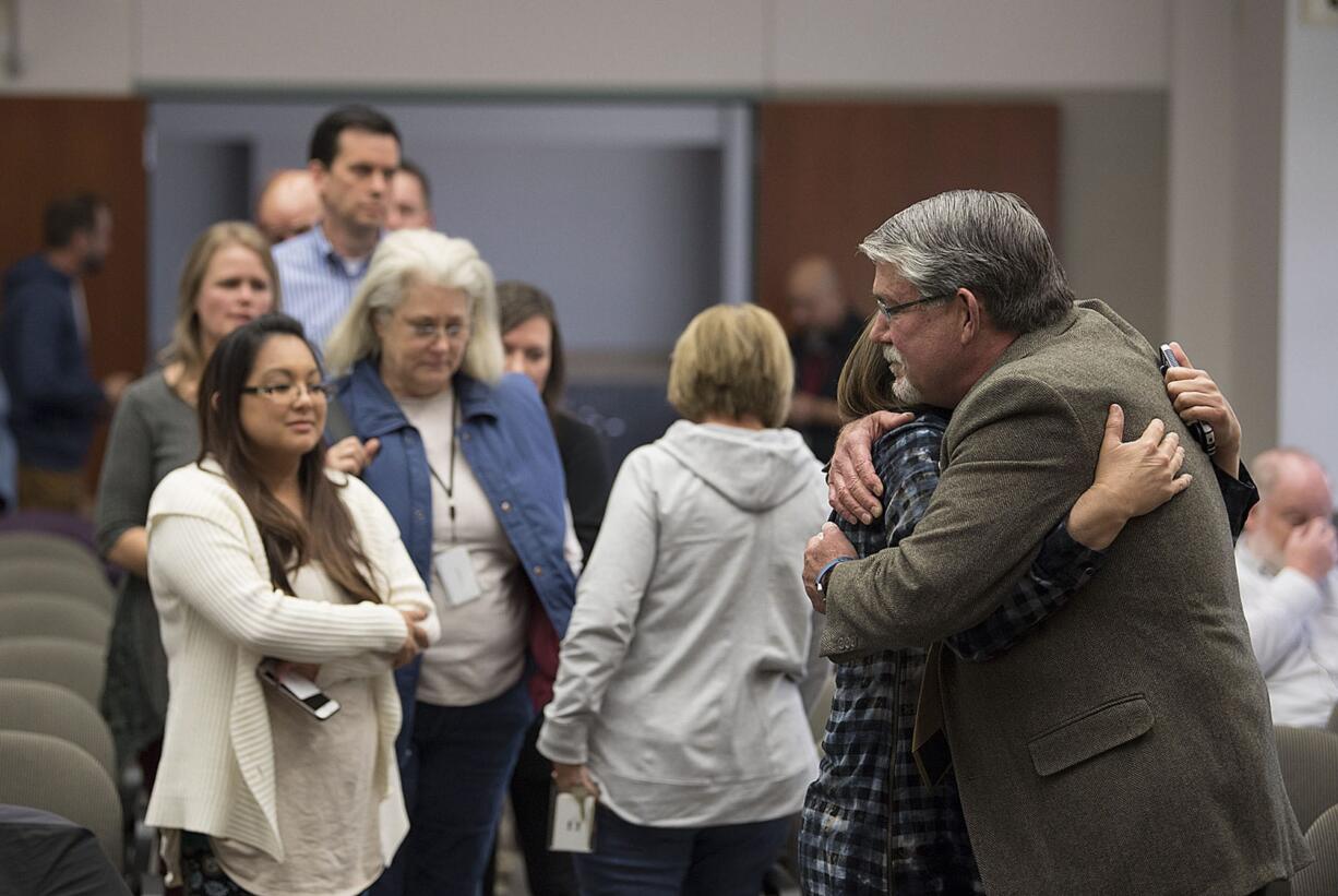 A line of colleagues, friends and supporters wait to embrace former Clark County Manager Mark McCauley, right, following the meeting at the Clark County Public Service Center on Friday afternoon.