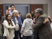 A line of colleagues, friends and supporters wait to embrace former Clark County Manager Mark McCauley, right, following the meeting at the Clark County Public Service Center on Friday afternoon.