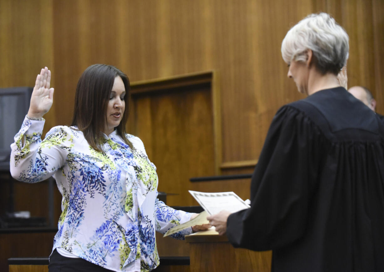 Newly appointed Clark County District Court Judge Kristen L. Parcher, left, is sworn in to the bench by District Court Judge Sonya L. Langsdorf during a ceremony Tuesday afternoon at the Clark County Courthouse. Parcher replaces District Court Judge Vernon L. Schreiber, who died April 25 at the age of 74.