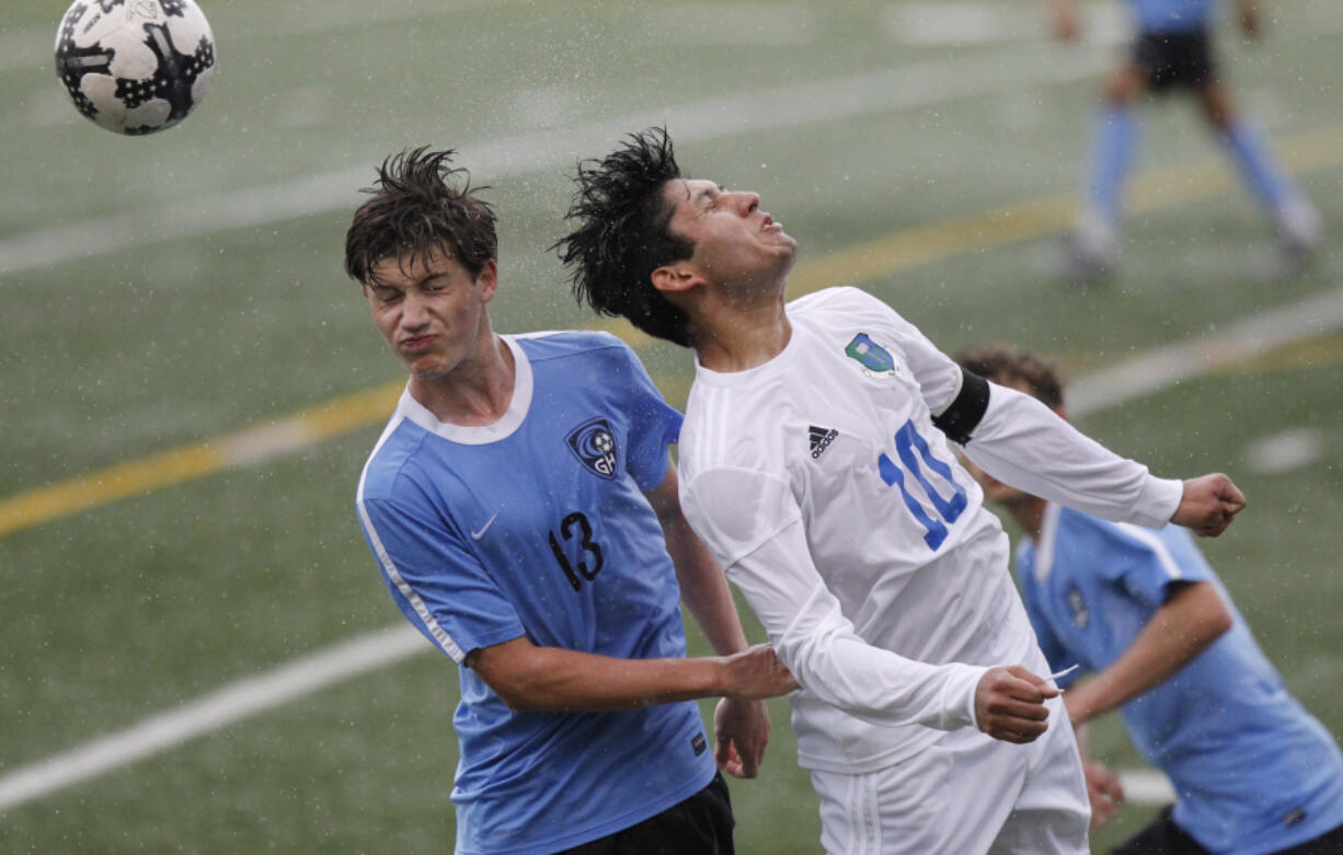 (Steve Dipaola/For The Columbian
Gig Harbor’s Luke Northstrom, left, and Mountain View’s Bryan Valdez head the ball in bi-district soccer tournament game at McKenzie Stadium.