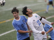 (Steve Dipaola/For The Columbian
Gig Harbor’s Luke Northstrom, left, and Mountain View’s Bryan Valdez head the ball in bi-district soccer tournament game at McKenzie Stadium.