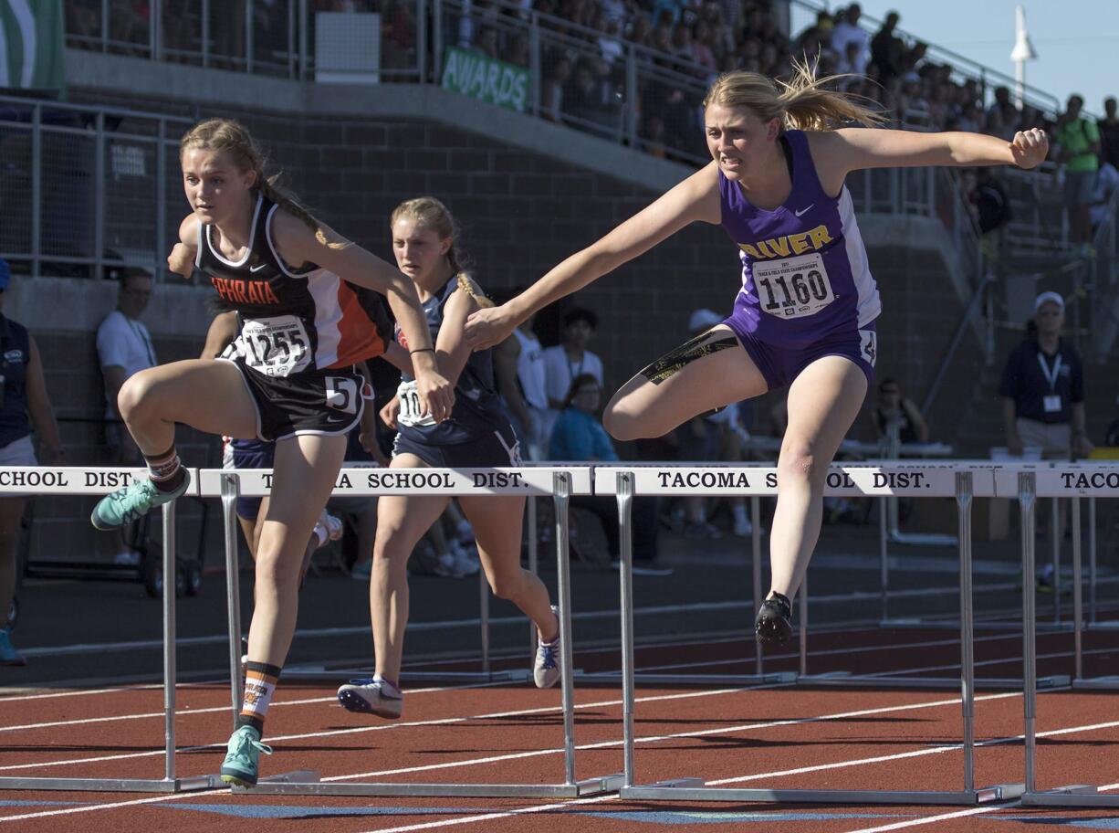 Columbia River's Ellie Walker, right, battles with Ephrata's McCall DeChenne, left, as they clear the final hurdle in the 2A Girls 100 Meter Hurdles event at the WA State Track and Field Meet Friday, May 26, 2017, in Tacoma, Wash. Walker had to settle for 2nd place finishing behind DeChenne.