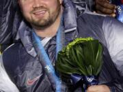 Steven Holcomb poses with his gold medal in the men's four-man bobsled during the medal ceremony at the Vancouver 2010 Olympics in Whistler, British Columbia. Holcomb, the longtime U.S. bobsledding star who drove to three Olympic medals after beating a disease that nearly robbed him of his eyesight, was found dead in Lake Placid, N.Y., on Saturday, May 6, 2017. He was 37.