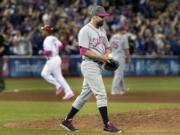 Seattle Mariners pitcher Nick Vincent walks off the mound after giving up a three-run home run to Toronto Blue Jays' Jose Bautista in the seventh inning of a baseball game in Toronto on Saturday May 13, 2017.