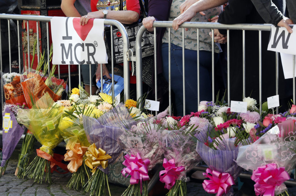 People attend a vigil in Albert Square, Manchester, England, Tuesday May 23, 2017, the day after the suicide attack at an Ariana Grande concert that left 22 people dead as it ended on Monday night.