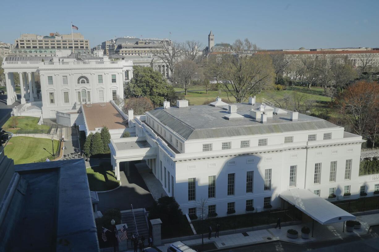 In this photo taken March 29, 2017, the main residence of the White House in Washington and the West Wing, right, as seen, Wednesday from the Eisenhower Executive Office Building on the White House complex in Washington. A top White House communications staffer has resigned as President Donald Trump considers overhauling his White House staff over frustrations that his team is struggling to contain the burgeoning crisis involving alleged Russian meddling in the 2016 election.